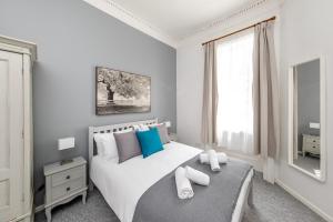 a bedroom with a white bed with a window at Super City Centre Apartment - two bedrooms, perfect location in Bath