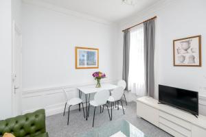 a white living room with a table and chairs at Super City Centre Apartment - two bedrooms, perfect location in Bath