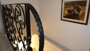 a black metal staircase with a picture on the wall at B&B Oliena in Oliena