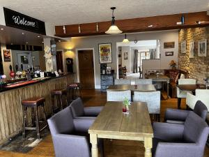 um restaurante com mesas e cadeiras e um bar em Crown & Anchor em Grantham