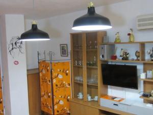 two lights hanging above a television in a room at 0318 Studio in Torremolinos 800 m from the beach in Torremolinos