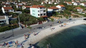a group of people on a beach near the water at Villa Luce in Vinišće