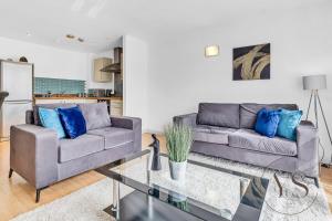 - un salon avec un canapé et une table dans l'établissement Riverside Apartment 2BR - Parking - Wi-Fi -Netflix, à Derby