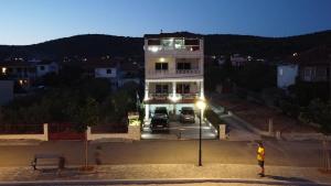 a man is standing in front of a building at Villa Luce in Vinišće