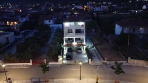 a house with cars parked in a parking lot at night at Villa Luce in Vinišće