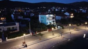 a city at night with lights on a street at Villa Luce in Vinišće +38 photos