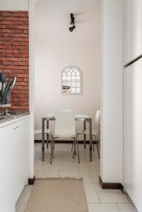 a kitchen with a table and chairs in a room at Appartamento Pescherie - Top location in Bologna