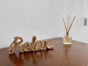 a wooden table with a glass vase and the word faith at REEF Beachfront 3BDR apartment by CASA PARAISO in Cancún