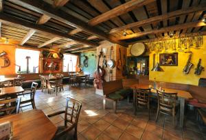 a restaurant with tables and chairs in a room at Rodinný penzion Skiland in Ostružná