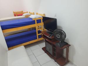 a bedroom with a bunk bed and a television at apartamento ADE 101, wifi in Brasilia +15 photos