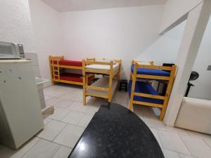 a kitchen with a table and chairs and a refrigerator at apartamento ADE 101, wifi in Brasilia