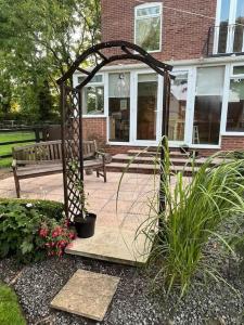 a garden with a gazebo in front of a house at 5A - ‘Your Place’ A Unique Space to make your own. in Elloughton