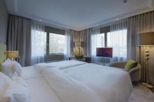 Ein Bett oder Betten in einem Zimmer der Unterkunft Insel-Hotel Heilbronn