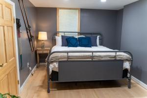 a bedroom with a bed with blue pillows at Ski Jump Chalet in Lake Placid