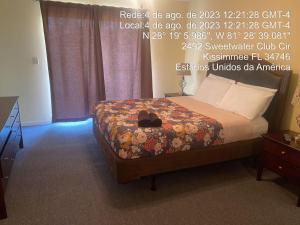 a bedroom with a bed with a dresser and avertisement at Sweet retreat condo resort in Kissimmee +24 photos