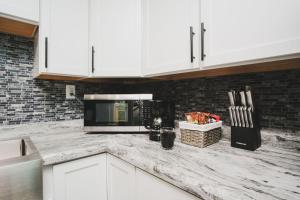 a kitchen with white cabinets and a counter top at Buckeye Lake Cottage in Hebron