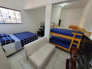 a bedroom with a bed and a couch in it at apartamento ADE 101, wifi in Brasilia