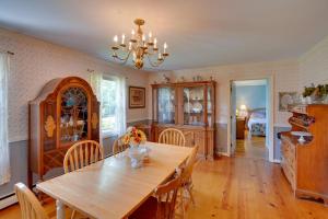 a dining room with a wooden table and chairs at Pittsfield Home with Deck - 12 Mi to Jiminy Peak! in Pittsfield