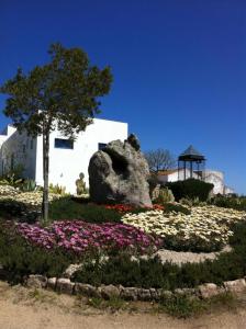 a garden of flowers in front of a white building at Herdade Do Charito in Elvas