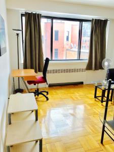 a room with a desk and a chair and a window at Stylish Montreal Apartment: Comfortable Stay in the Golden Square Mile in Montreal