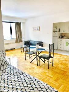 a living room with a table and chairs at Stylish Montreal Apartment: Comfortable Stay in the Golden Square Mile in Montreal