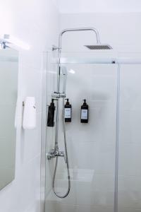 a shower with a shower head in a bathroom at Triana Riverside Guesthouse in Seville