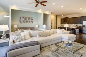 a living room with a white couch and a kitchen at Houston Home with Rooftop Patio Less Than 1 Mi to Aquarium! in Houston