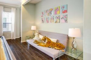 two tigers sitting on a couch in a living room at Houston Home with Rooftop Patio Less Than 1 Mi to Aquarium! in Houston