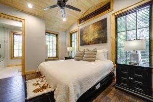 a bedroom with a bed and a ceiling fan at Grill and Water Views Chinquapin Resort Home in Glenville