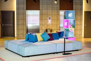 a bed with colorful pillows on it in a room at Aloft by Marriott Playa del Carmen in Playa del Carmen +46 photos