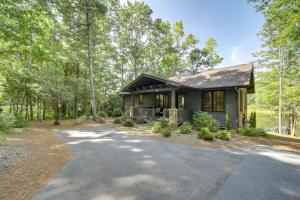 a small green house with a driveway at Grill and Water Views Chinquapin Resort Home in Glenville