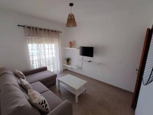 a living room with a couch and a table at Apartamento para férias-Nazaré in Nazaré