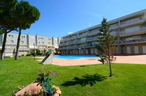 a large building with a courtyard with a swimming pool at Els Pins - L'Escala in L'Escala