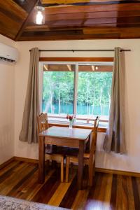 a dining room with a table and a window at Crystal Creek Lodge in Orange Walk