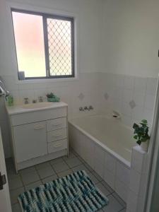 a bathroom with a tub and a sink and a bath tub at Holiday home with fantastic location in Springwood