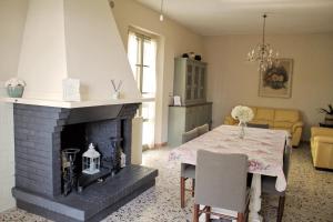 a living room with a table and a fireplace at il nuvoloso in Città della Pieve
