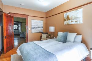 a bedroom with a large bed and a bathroom at 1907 Stone House - King Bed, Office, Crib, Toys in San Diego