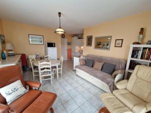 a living room with a couch and a table at Chatelaillon-Plage Centre-Ville: Apt 4 pers, balcon, parking, piscine, wifi - FR-1-706-21 in Châtelaillon-Plage