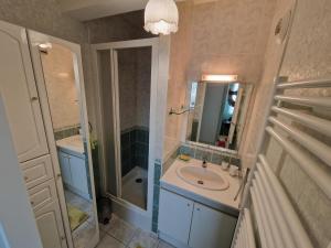 a bathroom with a sink and a shower and a mirror at Chatelaillon-Plage Centre-Ville: Apt 4 pers, balcon, parking, piscine, wifi - FR-1-706-21 in Châtelaillon-Plage +4 photos