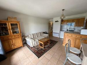 a living room with a couch and a kitchen at Appartement Les Angles, 3 pièces, 6 personnes - FR-1-593-93 in Les Angles