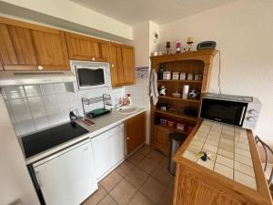 a small kitchen with a sink and a microwave at Appartement Les Angles, 3 pièces, 6 personnes - FR-1-593-93 in Les Angles