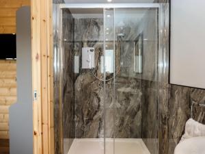 a shower with a glass door in a bathroom at Foxglove Lodge in Exeter +26 photos