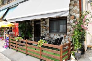 a restaurant with a table and chairs in front of a building at Meteora's unique gem in Kastrákion