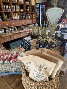 a display of wine bottles in baskets on a table at Camping De La Sarre in Abreschviller