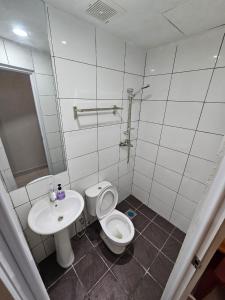 a bathroom with a toilet and a sink at TT99 COZY STAY in Miri +26 photos