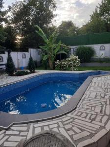 a small swimming pool in a yard with a patio at Garden- pool apartman 
