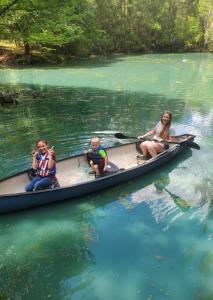 a group of people in a canoe in the water at Waterfront Treehouse in a Magical Forest in Waller