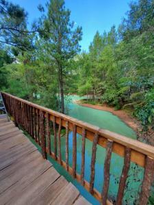 a wooden bridge with a view of a river at Waterfront Treehouse in a Magical Forest in Waller
