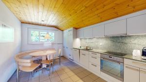 a kitchen with a table and a dining room at Haus Leibnitzer in St. Moritz