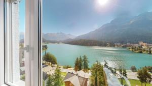 a view of a lake from a window at Haus Leibnitzer in St. Moritz